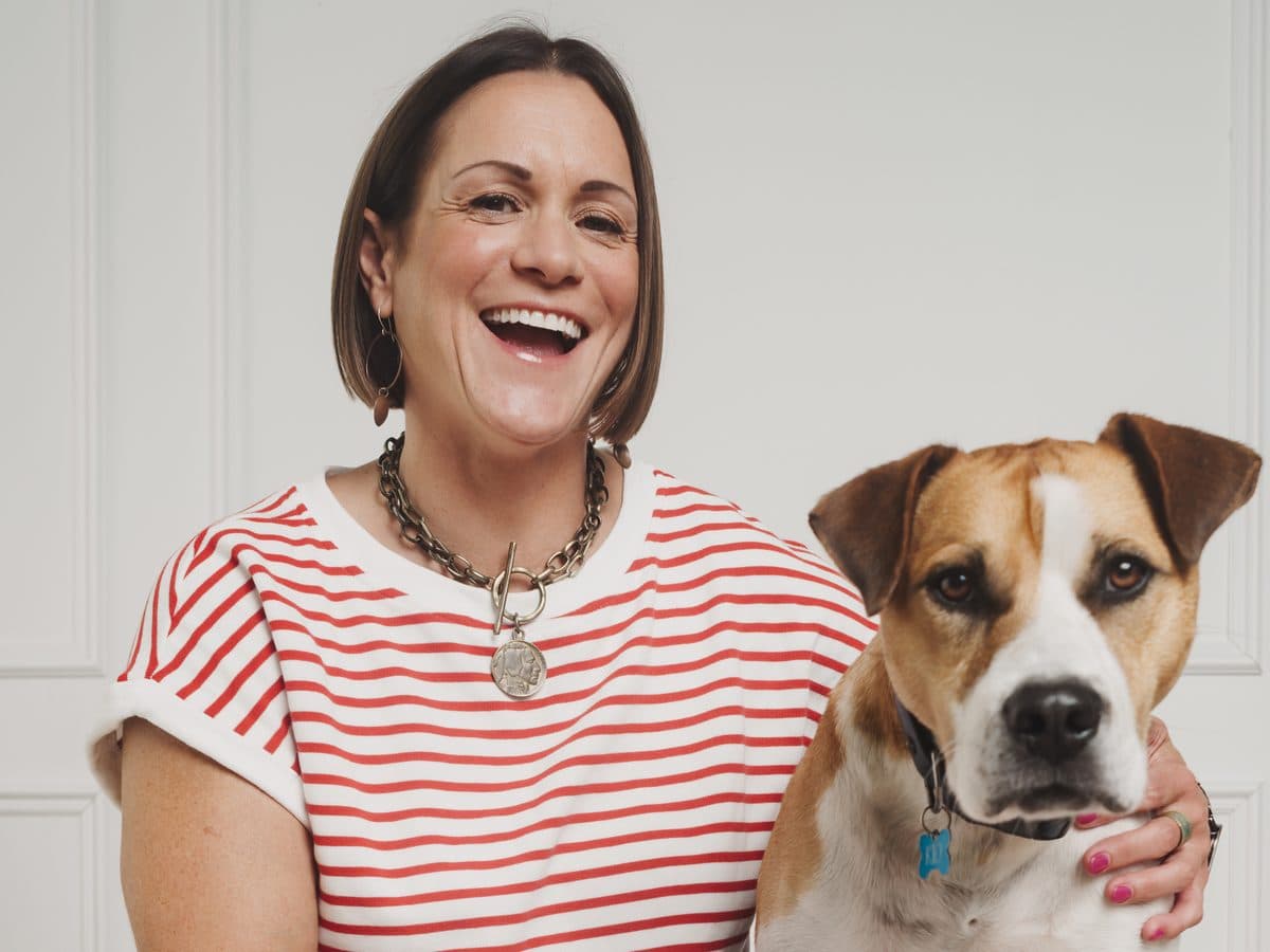 Business owner laughing with her dog