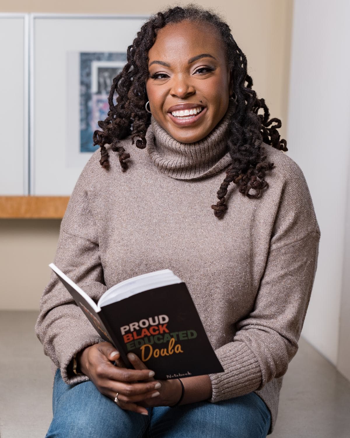 Smiling author holding her book