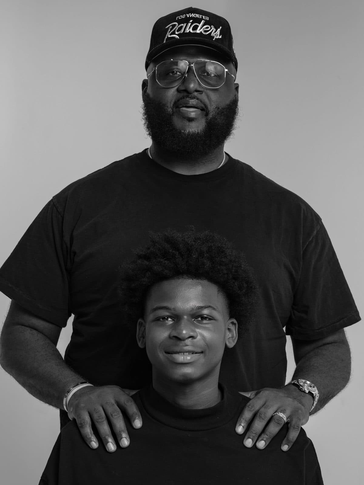 Father standing behind his son with hands on his shoulders
