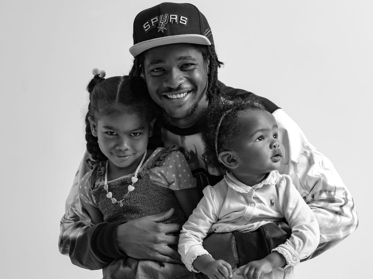 Father holding his two daughters