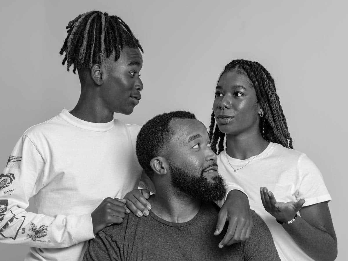 Father seated with his teenage children