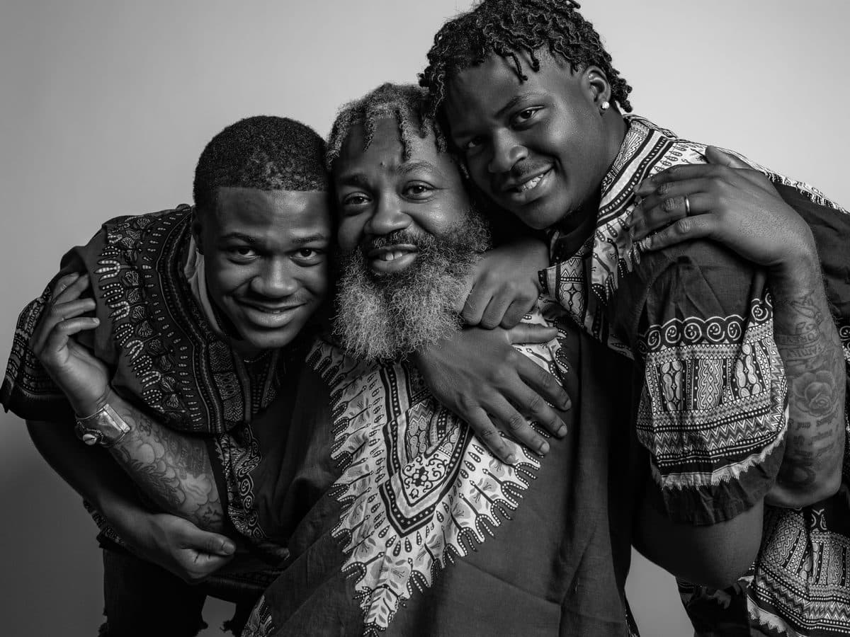 Grandfather, father and son embracing