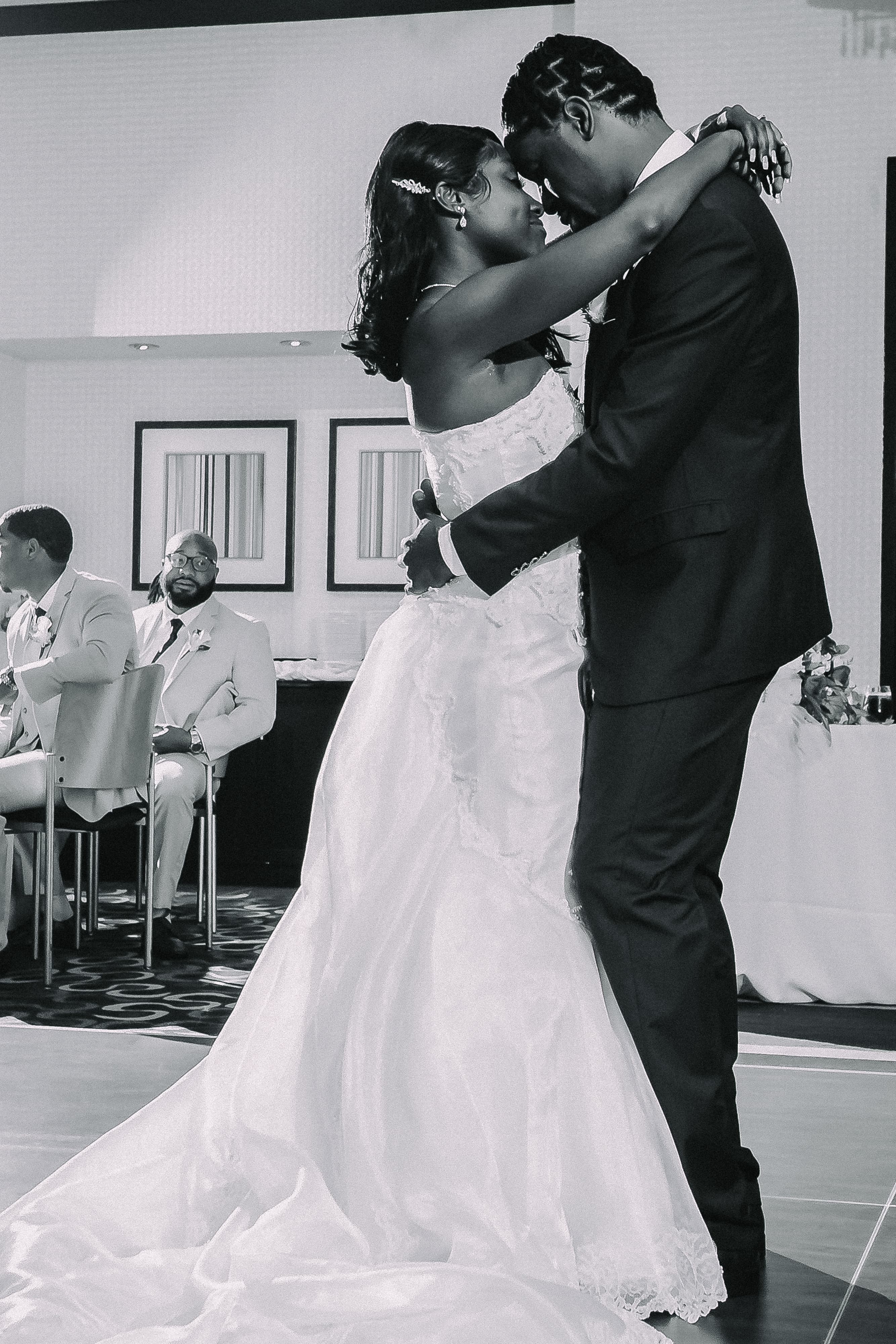 Black-and-white first dance photograph of a couple touching foreheads